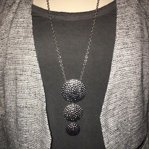 Long silver statement necklace.